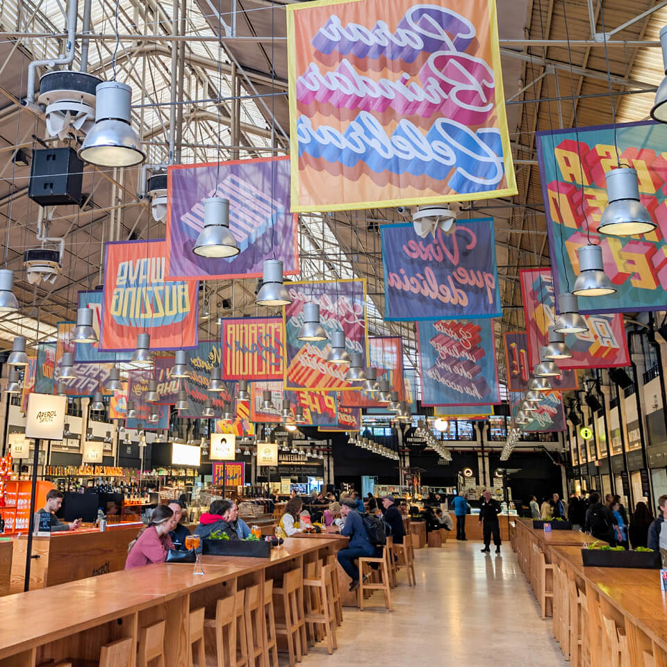 The bustling interior of the Time Out Market inside Mercado da Ribeira, Lisbon
