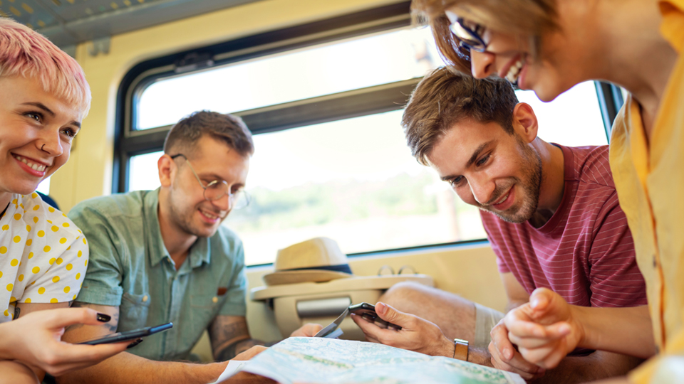 A group of friends planning their trip on a train