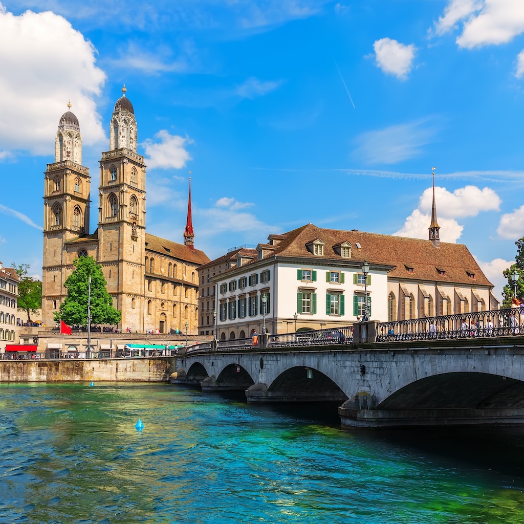 A breathtaking capture of the Grossmünster with the Limmat river flowing next to it